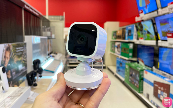 Hand Holding Amazon Blink Mini 1080p Security Camera in Store