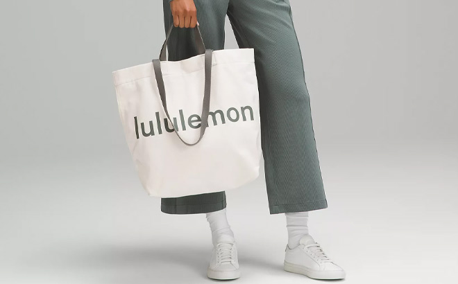 Hand Holding Lululemon Double Handle Canvas Tote Bag