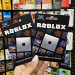 Hand Holding Roblox Gift Cards