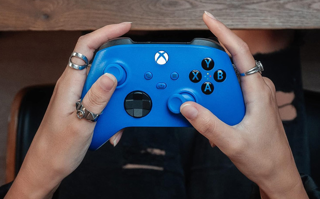 Hand Holding Xbox Wireless Controller Shock in Blue Color