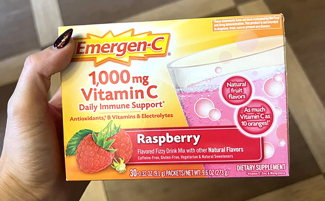 Hand Holding an Emergen C 1000mg Vitamin C Powder Raspberry Flavor