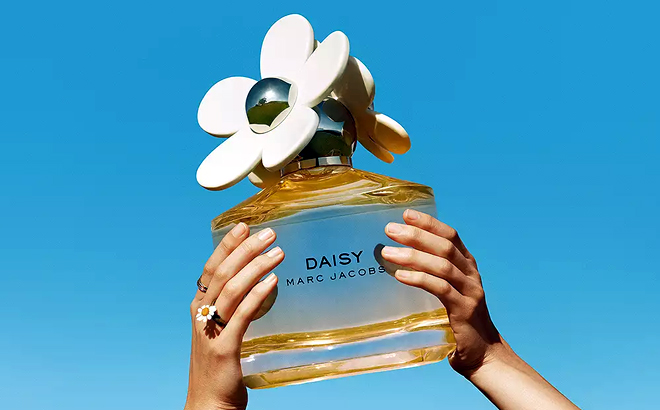 Hand holding MARC JACOBS Daisy Eau So Fresh Eau de Toilette