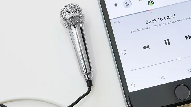 Kikkerland Mini Karaoke Microphone Next to a Phone