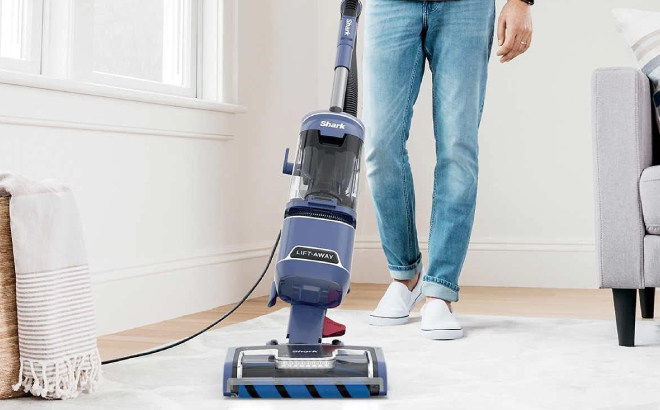 Man Cleaning a Carpet Using the Shark DuoClean Performance Lift Away Upright Vacuum