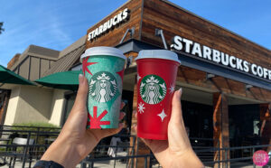 People Holding the Two Holiday Starbucks Cups in Front of Starbucks Store