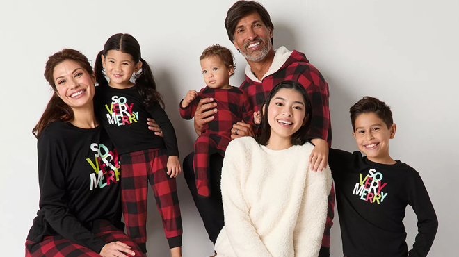 People wearing So Very Merry Plaid Matching Family Pajamas