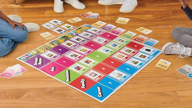 The Game of Life Giant Edition Family Board Game on a Wooden Floor