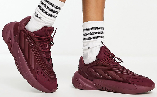 Woman is Wearing Adidas Ozelia Sneakers in Burgundy Color