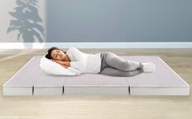 Woman sleeping on Folding Portable Mattress Topper