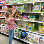 Woman with child checking out toys on the shelf at Target