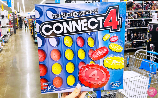 a Hand Holding Hasbro Gaming Connect 4 Game