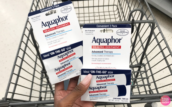 a Hand Holding two Aquaphor Ointment 2 Packs