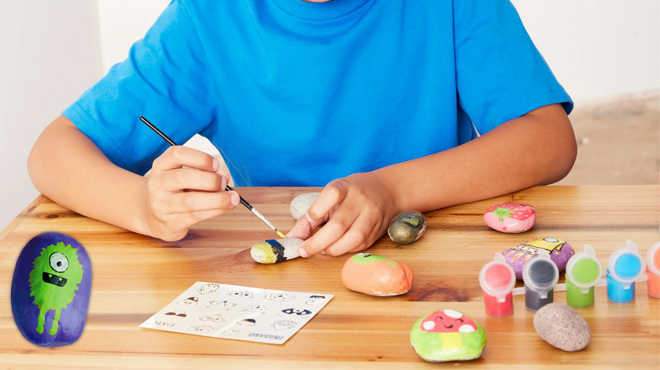 a Kid Painting Using a Creativity for Kids Rock Painting Kit