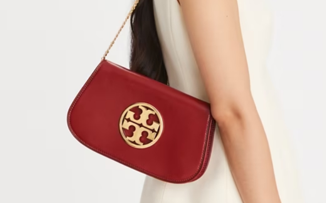 a Person Carrying a Tory Burch Reva Clutch Bag