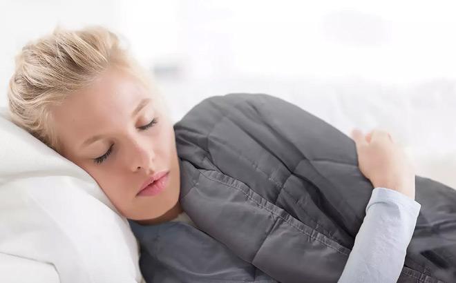 a Woman Sleeping Covered with Weighted Blanket