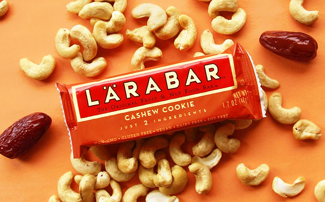 A Bar of Larabar Cashew Cookie Snack Bar with Nuts on the Sides