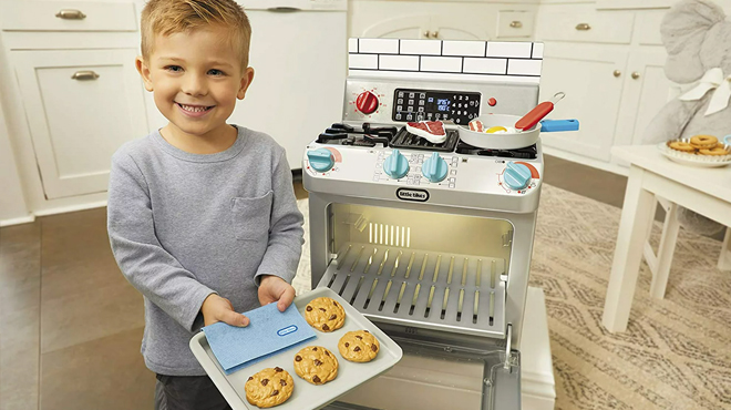 A Boy Playing With Litle Tikes First Oven Playset