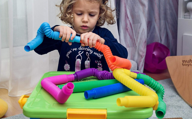 A Child Playing with Nutty Toys 8 Pack Pop Tubes Sensory Toys