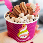 A Hand Holding Menchies Frozen Yogurt