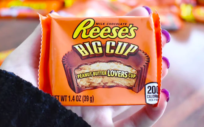 A Hand Holding Reeses Big Cup