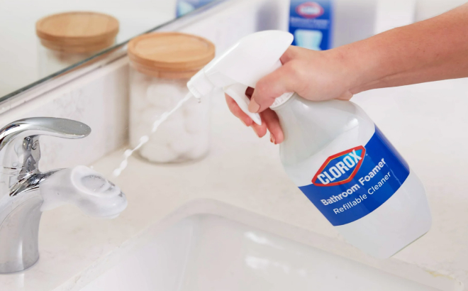 A Person Cleaning a Faucet Using the Clorox Multi Purpose Cleaner System Starter Kit