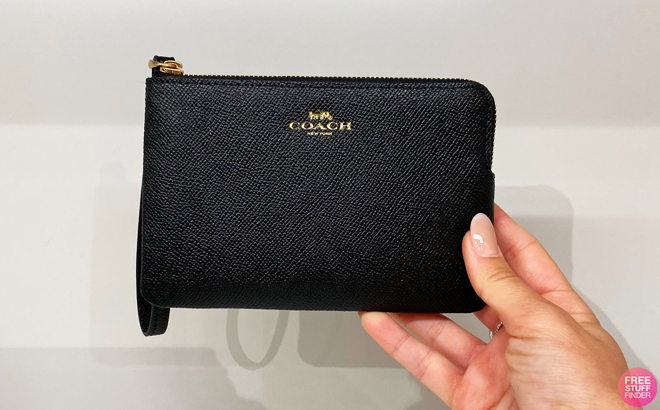 A Person Holding Large Coach Zip Corner Wristlet in Black Color