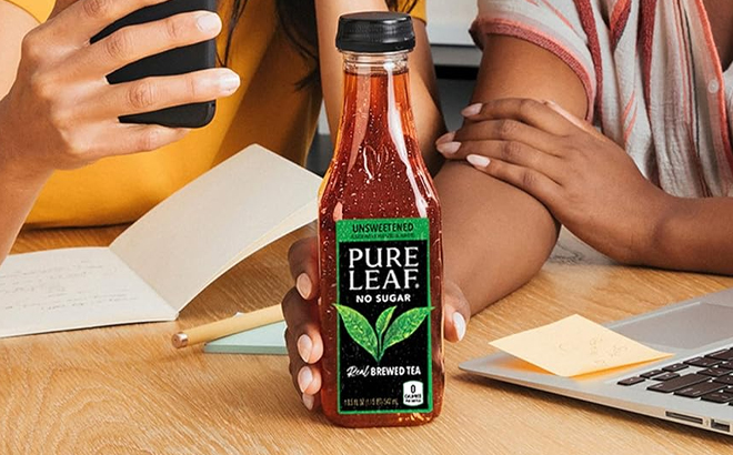 A Person Holding Pure Leaf Unsweetened Real Brewed Tea