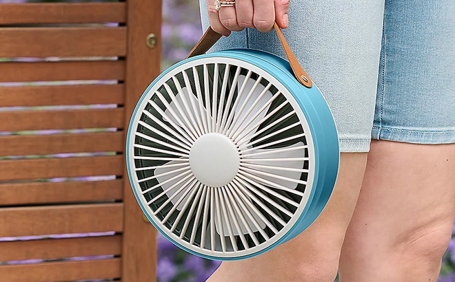 A Person Holding a Air Innovations Rechargeable Telescopic Fan