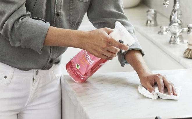 A Persong Spraying Method All Purpose Cleaner on Kitchen Counter Top