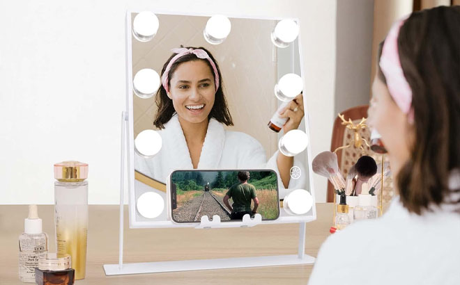 A Woman Infront of Vanity Makeup Mirror with Lights