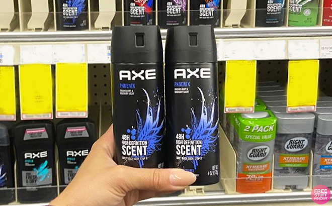 A person holding two bottles of Axe Phoenix Mens Body Spray