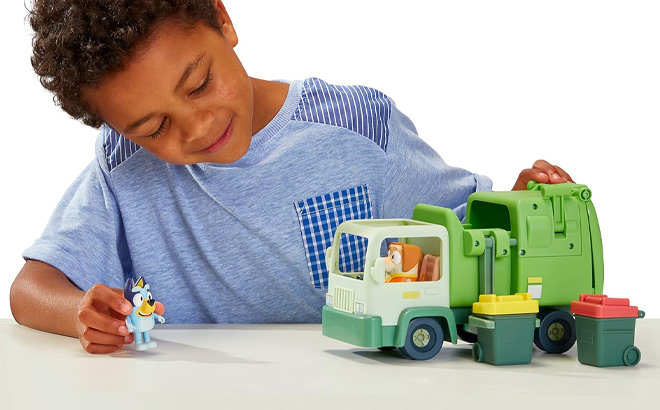 Boy is Playing with Bluey Garbage Truck Playset