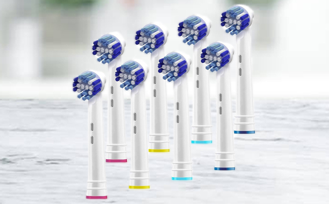 Eight Electric Toothbrush Heads on a Marble Table