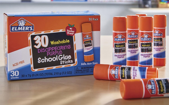 Elmers Disappearing Purple School Glue Sticks 30 Count on a Table