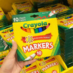 Hand Holding Crayola Broad Line Markers 10 Count at a Store