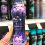 Hand Holding Downy Infusions Calm Laundry Scent Booster Beads in the Lavender Vanilla Bean Scent