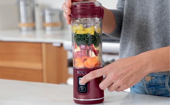 Hand Holding Ninja Blast 18 oz Portable Rechargeable Blender