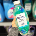 Hand Holding a Downy Rinse Refresh Fabric Softner