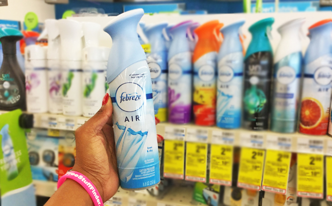 Hand Holding a Spray Bottle of Febreze Air Freshener Linen Sky