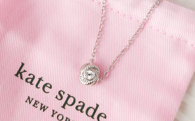 Kate Spade Infinity Beyond Knot Mini Pendant Necklace on a Dust Bag