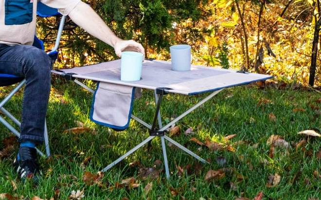 Man Getting a Cup from an Ozark Trail Portable Camping Table