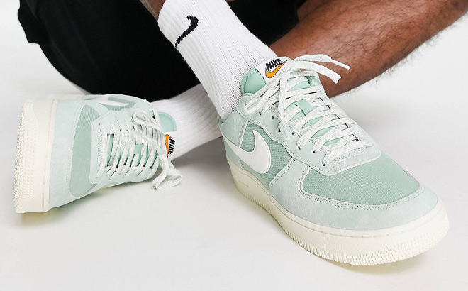 Man is Wearing Nike Air force 1 07 LV8 Shoes in Enamel Green Color