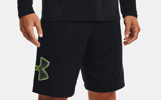 Man is Wearing Under Armour Mens Tech Graphic Shorts in Black and High Vis Yellow Color