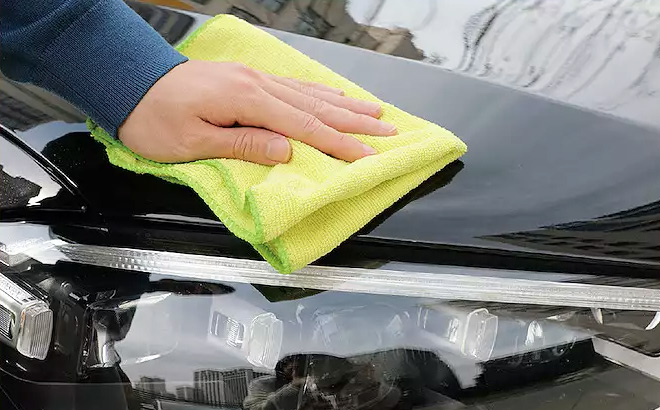 Person Cleaning The Exterior of a Car Using The Microfiber Towel