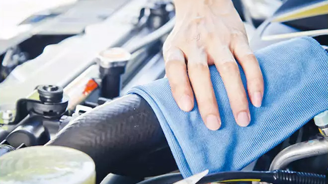 Person Cleaning Under The Hood of a Car Using The Microfiber Towel