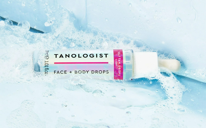 Tanologist Face and Body Self Tan Drops Light Bronzing Drops on a Blue Soapy Background