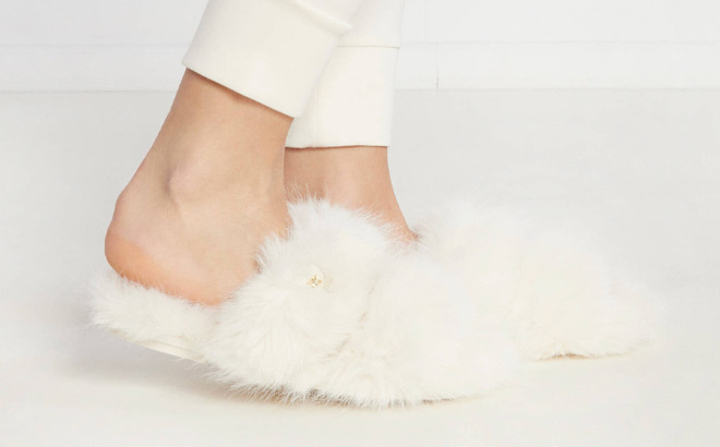 Woman is Wearing Michael Kors Tula Faux Fur Slides in Cream Color