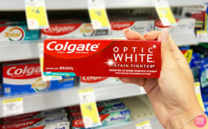 a Hand Holding Colgate Optic White Toothpaste