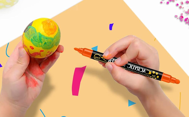 a Kid Painting an Egg with an Acrylic Marker