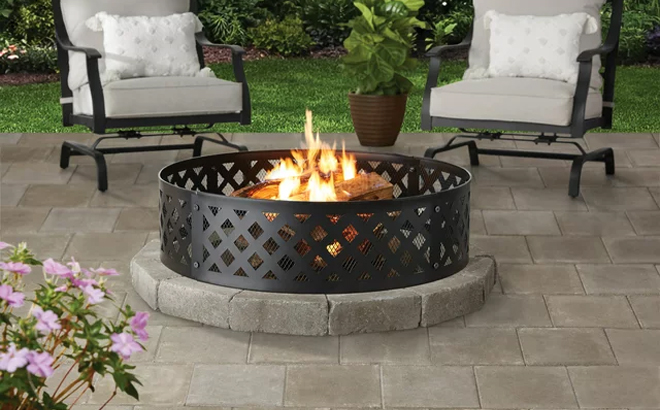 36 Inch Round Metal and Steel Fire Ring Black by Mainstays Placed in a Backyard Garden